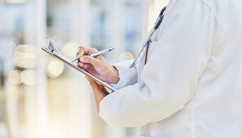 Hands, person or doctor writing on clipboard