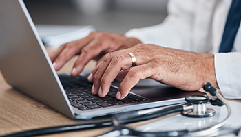 Doctor, hands and laptop for healthcare research